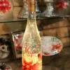Lighted Wine Bottle With Swirling Glitter Hope Poinsettia Design With Cardinals Snow Globe